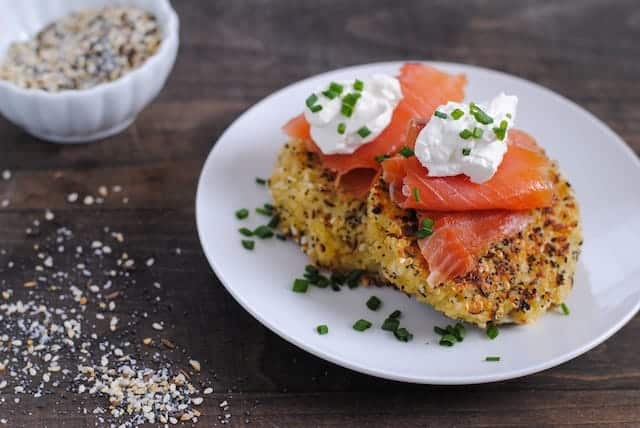 Everything bagel quinoa cakes topped with smoked salmon and crème fraiche.