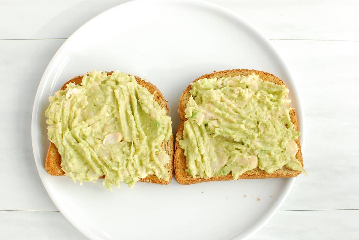 Mashed avocado and white beans spread on toast.