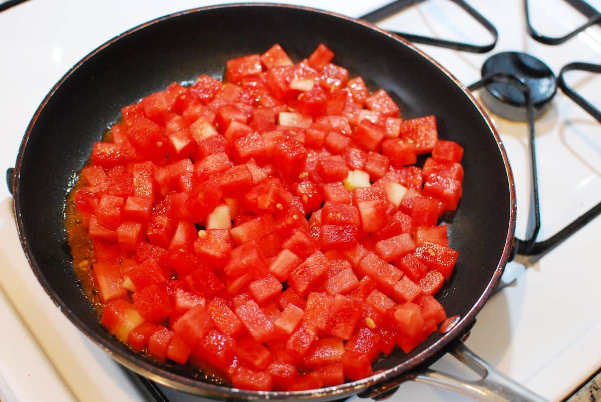 Watermelon in a skillet at the start of cooking.