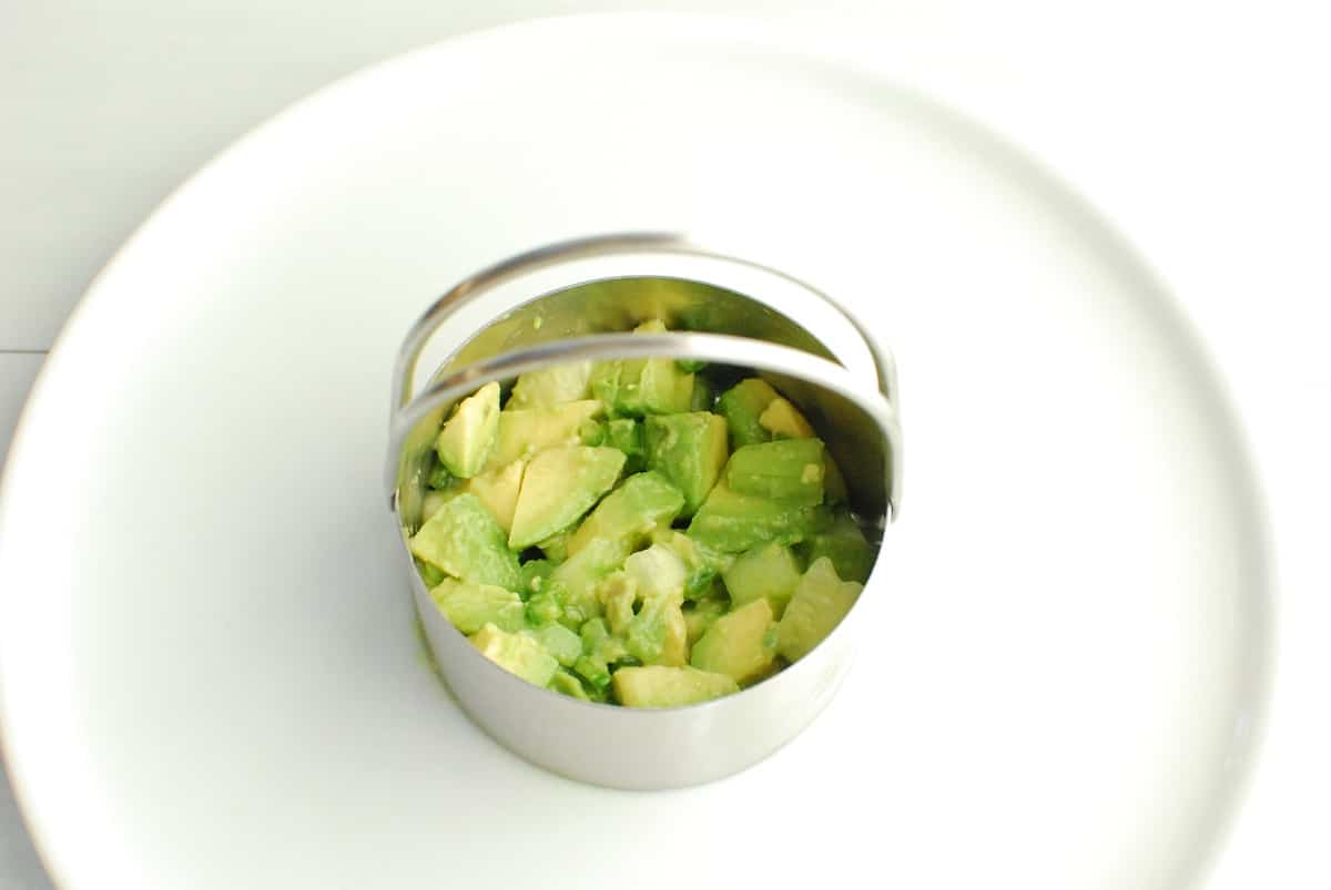 A food mold filled halfway with the avocado cucumber base.