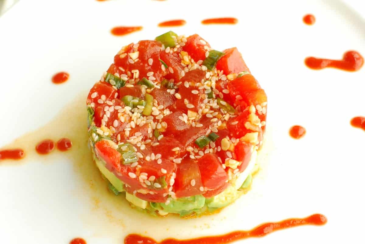 An overhead shot of watermelon tartare on a white plate.