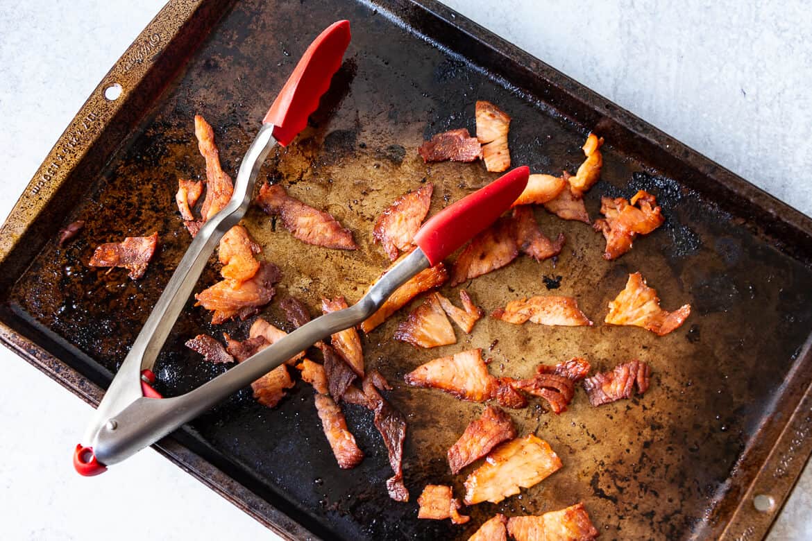 Homemade salmon bacon on a baking sheet.