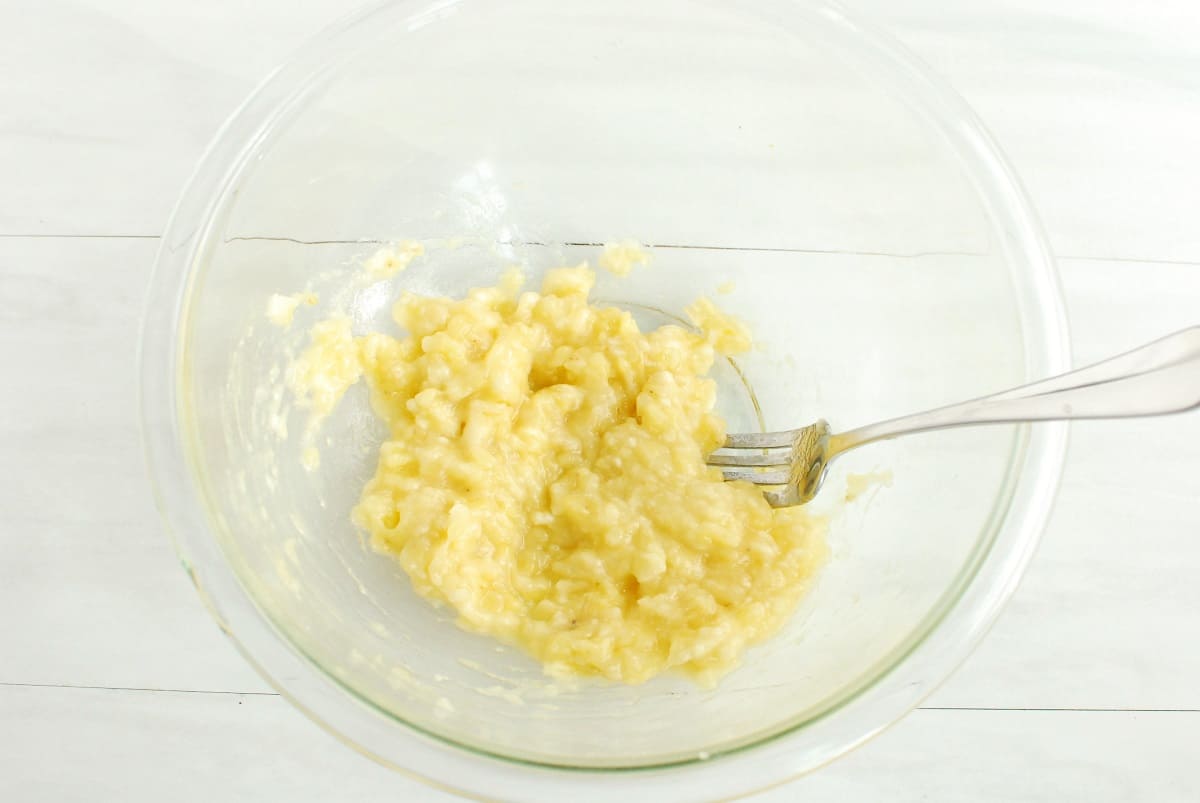 A mixing bowl with mashed bananas.