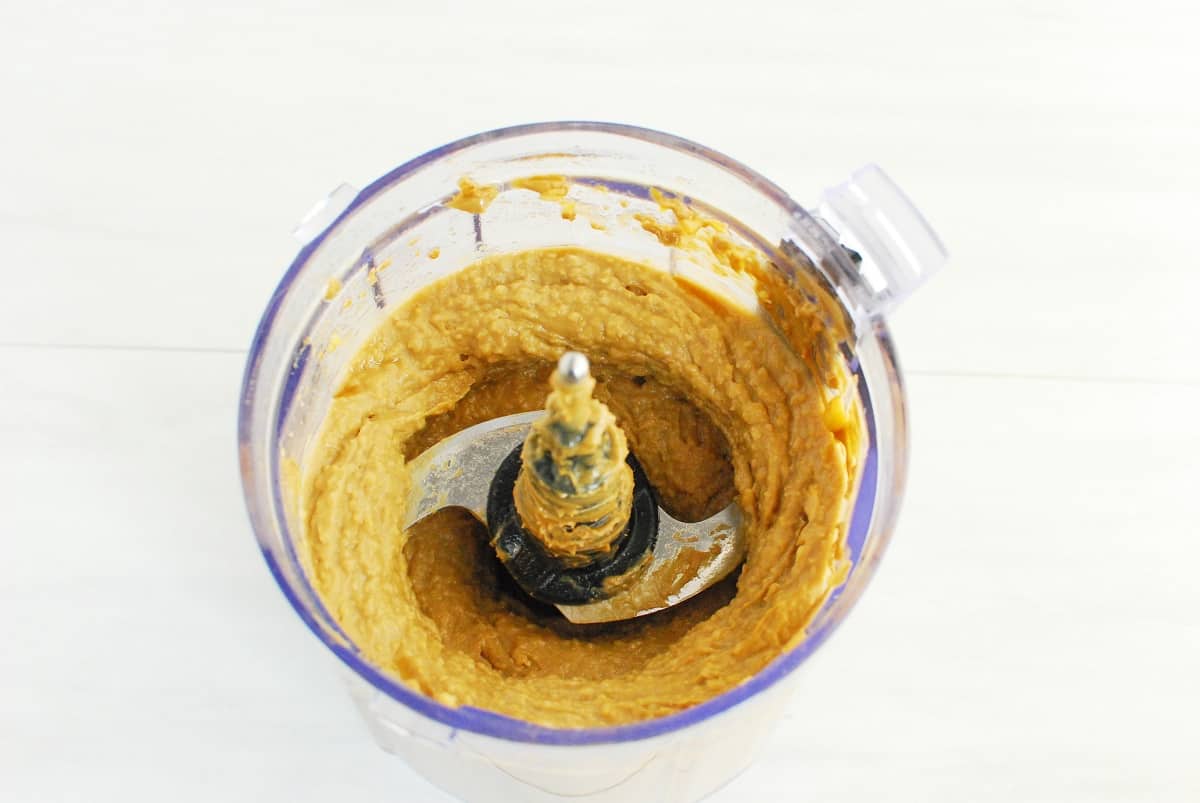 Chickpeas, sunflower seed butter, maple syrup, and vanilla extract blended together in a food processor.