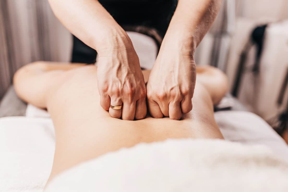 A woman getting  a massage on a massage table.