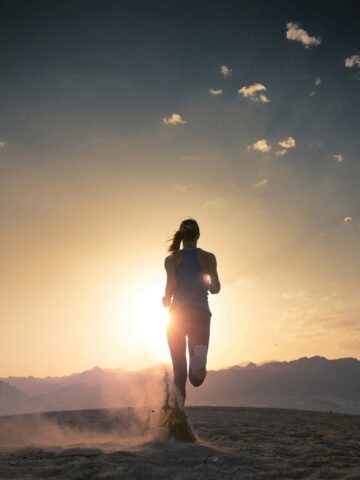 A runner doing an aerobic run outside during sunset.