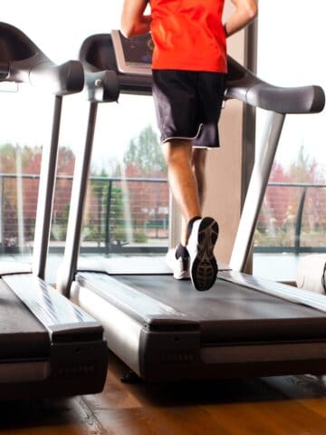 A man's legs running on a treadmill.