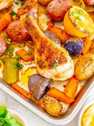 Cooked sheet pan chicken drumsticks and veggies.