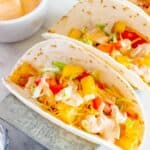 A close up of a spicy potato soft taco topped with chipotle Greek yogurt sauce.