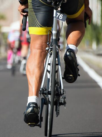 A triathlete riding a bike in a race.