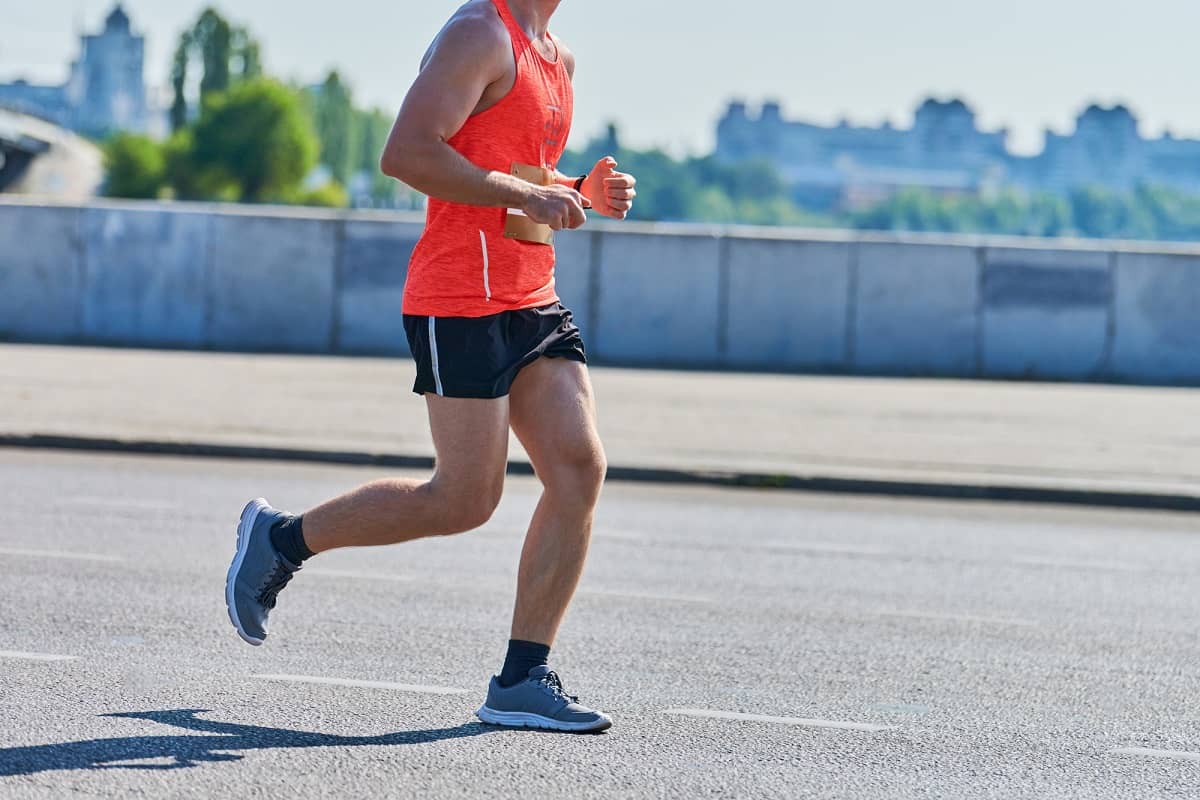 A man jogging outside on the road.