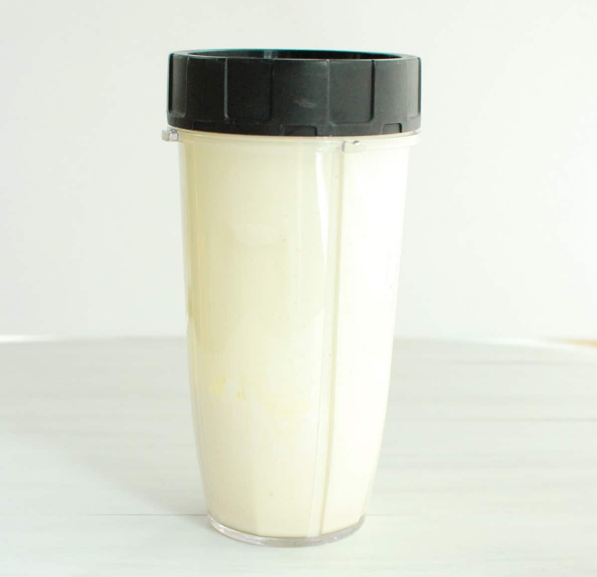 Cottage cheese and egg blended together in a blender cup.