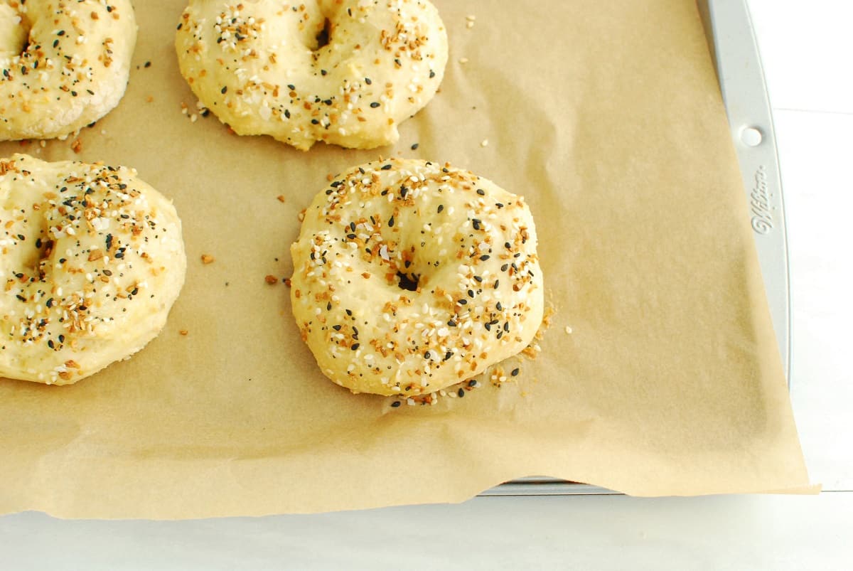 Cooked cottage cheese bagels on a baking sheet.