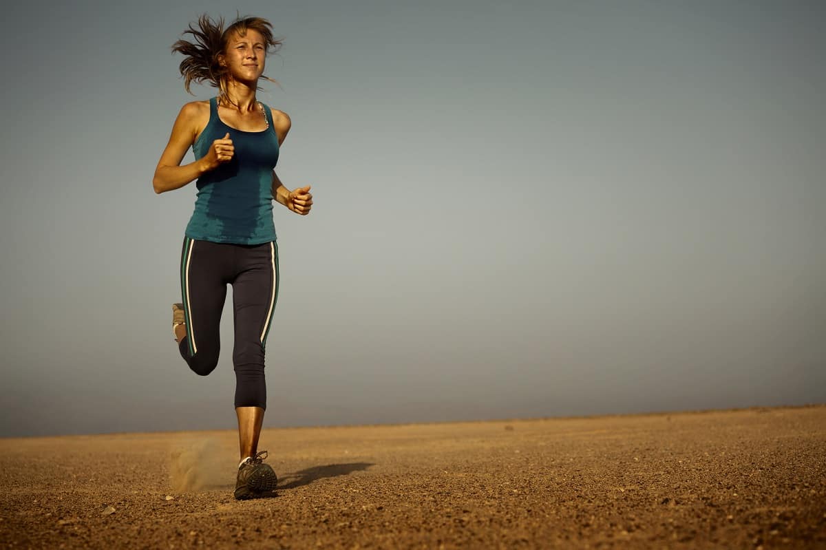 A runner sweating while running in dry hot conditions.