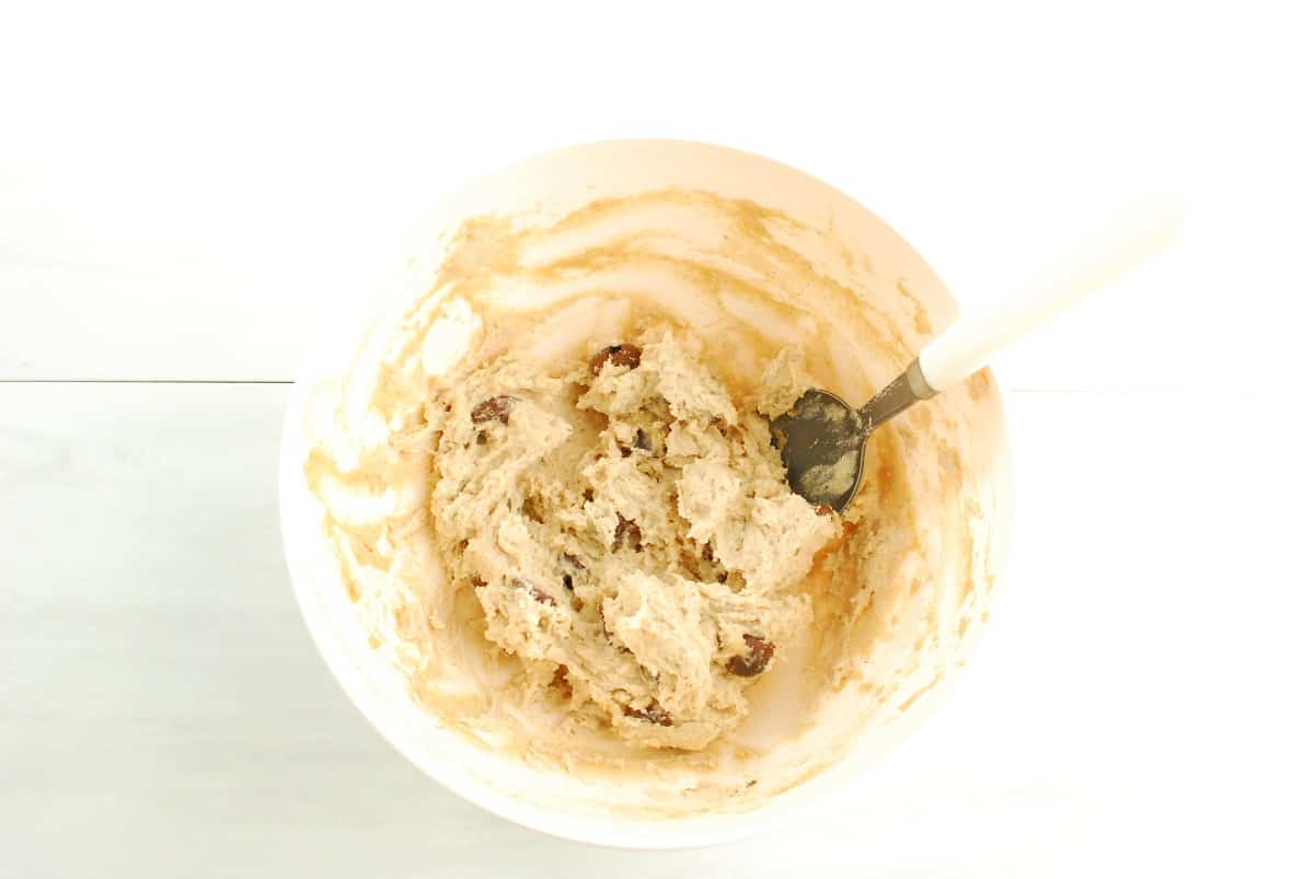 A bowl with the cottage cheese cookie dough ingredients mixed together.