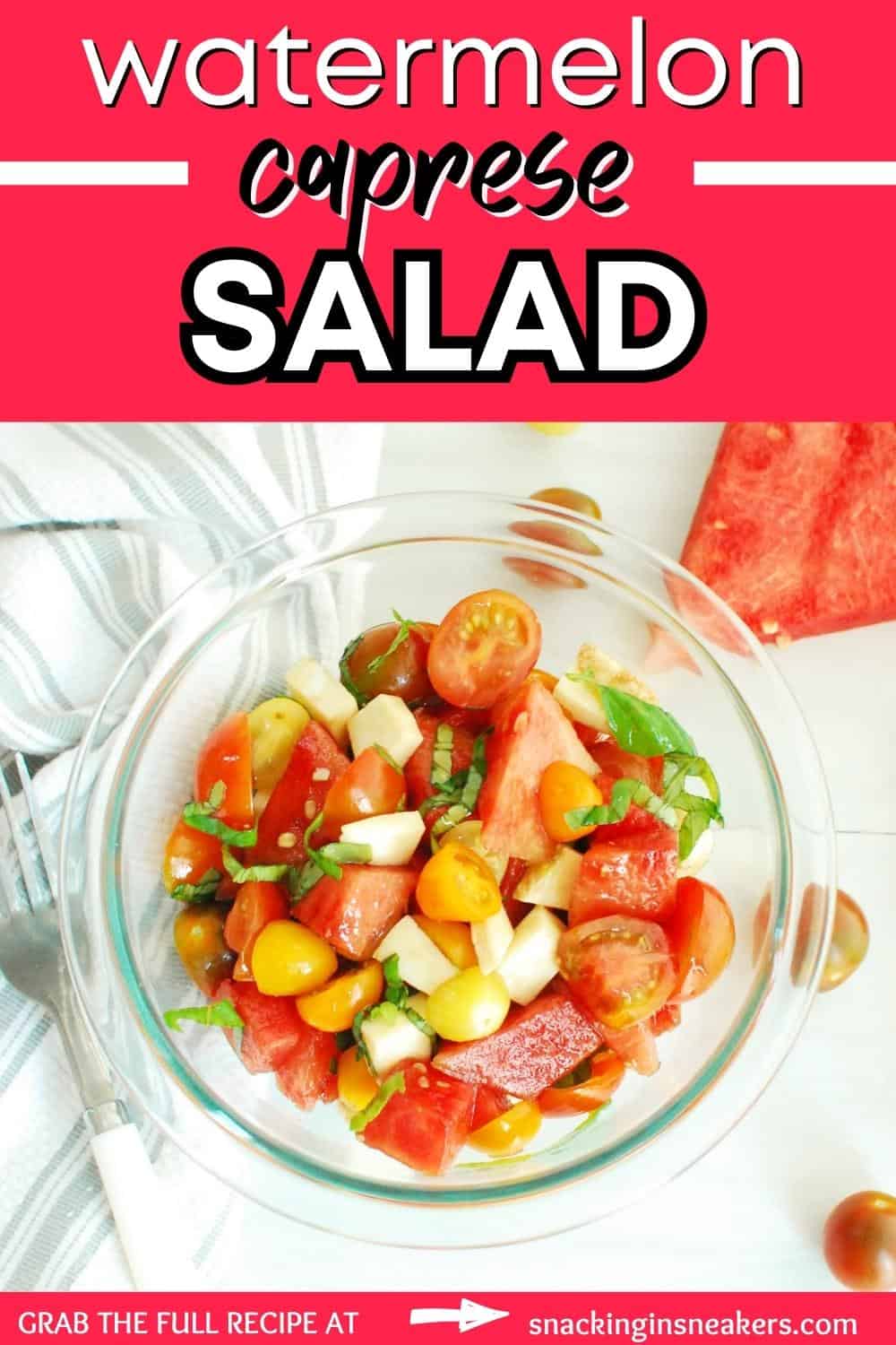 A bowl of watermelon caprese salad next to a napkin and some scattered cherry tomatoes, with a text overlay with the name of the recipe.