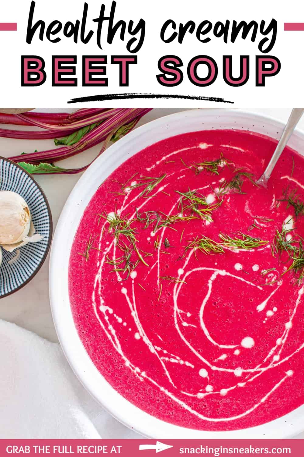 A bowl of beet soup garnished with half and half and dill, with a spoon sticking out the side, and a text overlay with the name of the recipe.