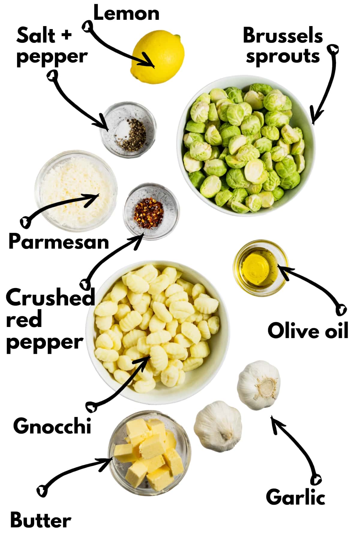 Gnocchi, brussels sprouts, oil, butter, garlic, salt, pepper, lemon, crushed red pepper, and parmesan on a white backdrop.
