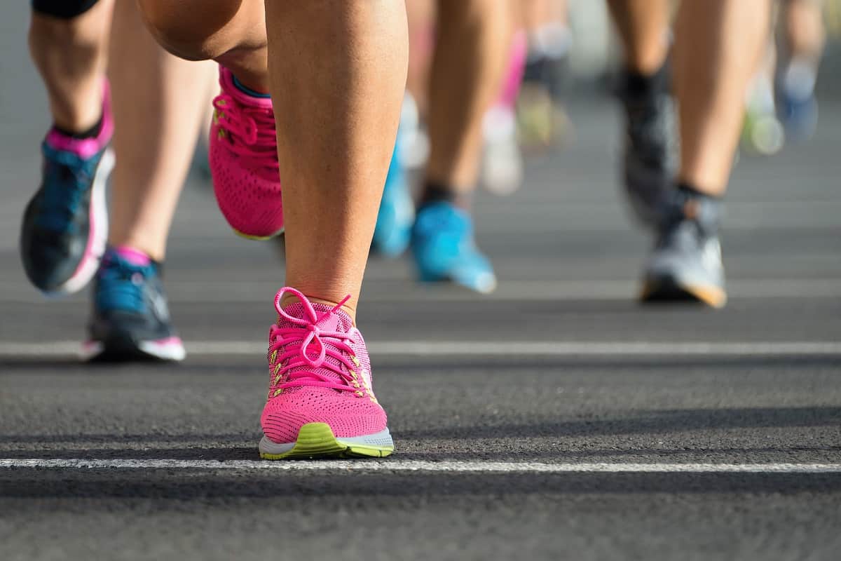 Close up of sneakers on a runner during a road race.