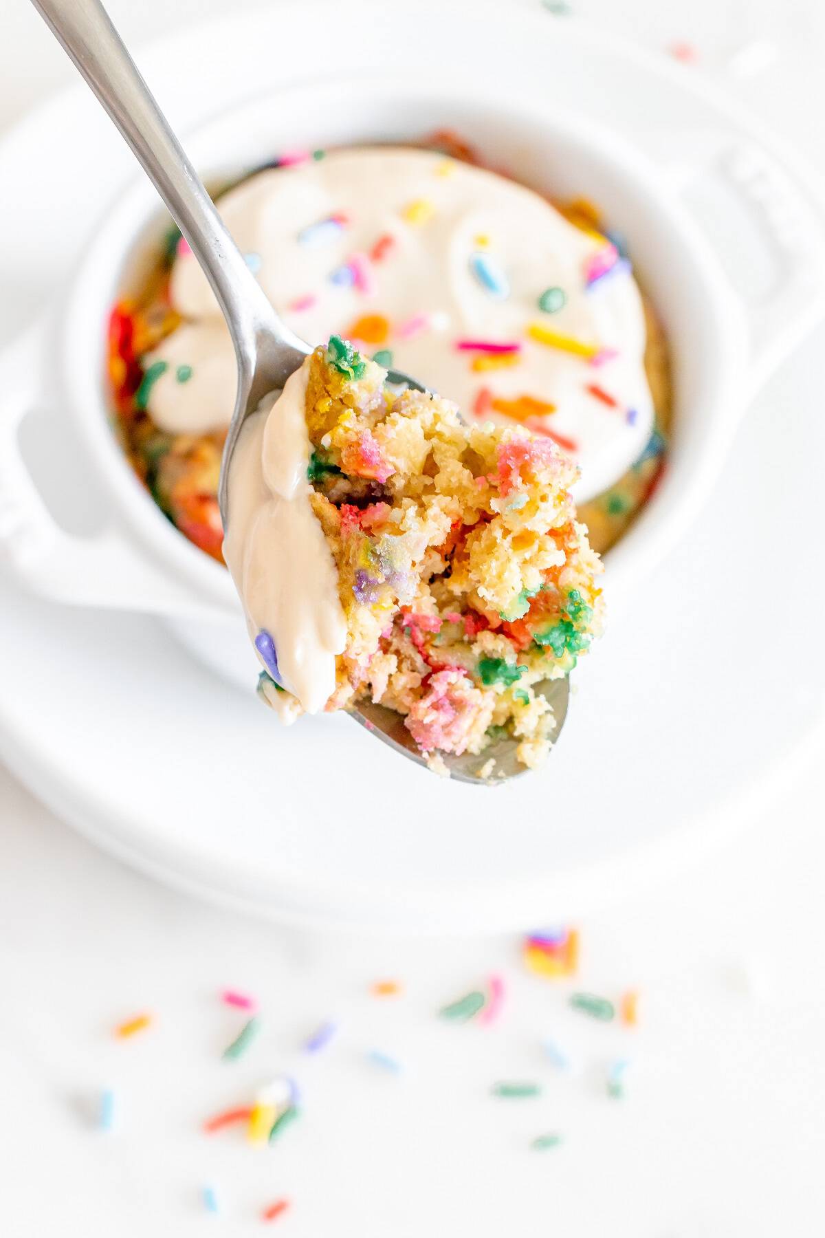A close up of a spoonful of birthday cake baked oatmeal.