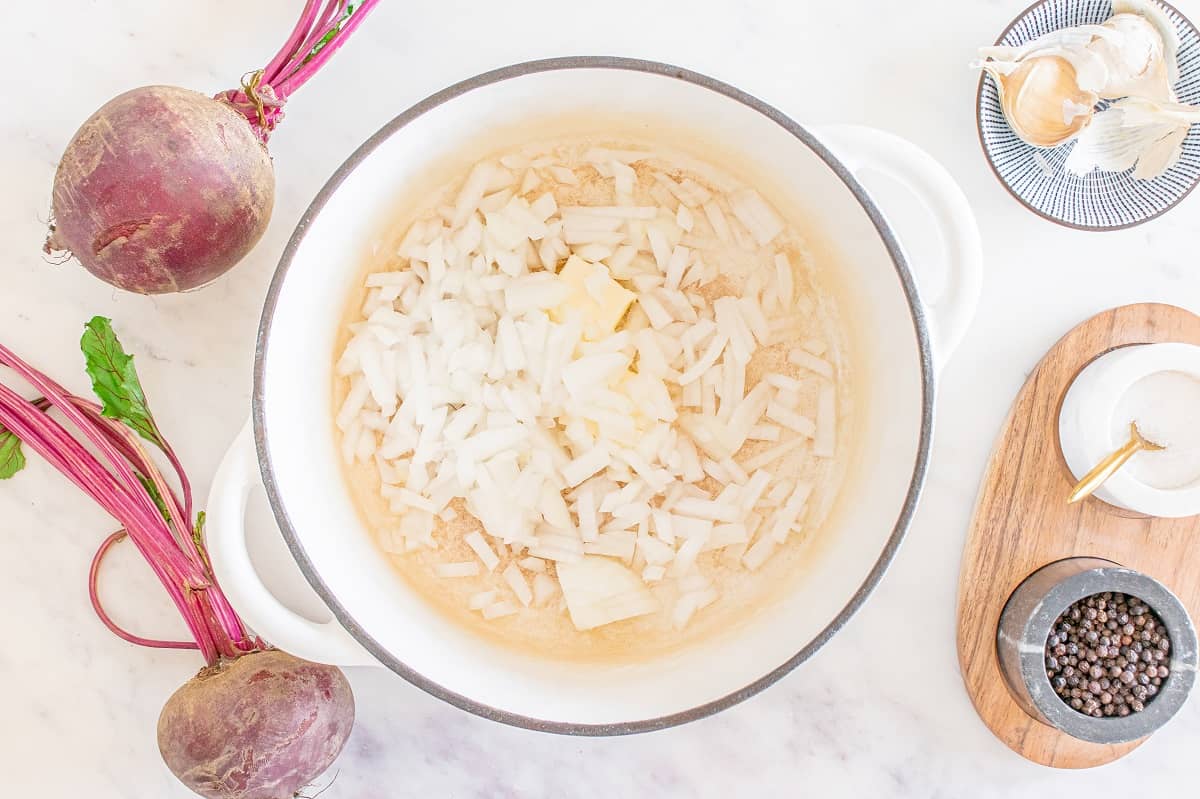 Onions sautéing in a pot with butter.