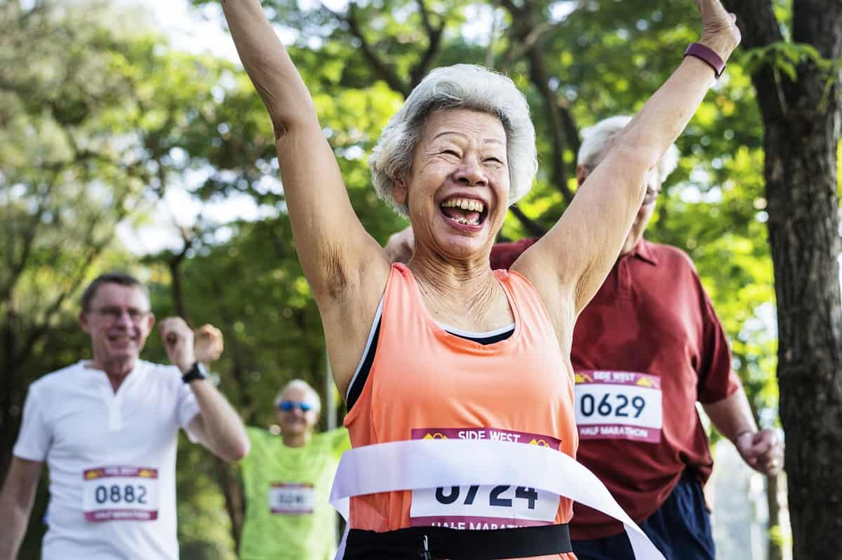 A woman having fun and excited to cross the finish line of a half marathon.