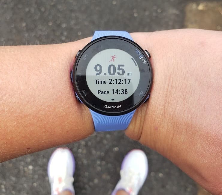 A garmin running watch on someone's wrist.