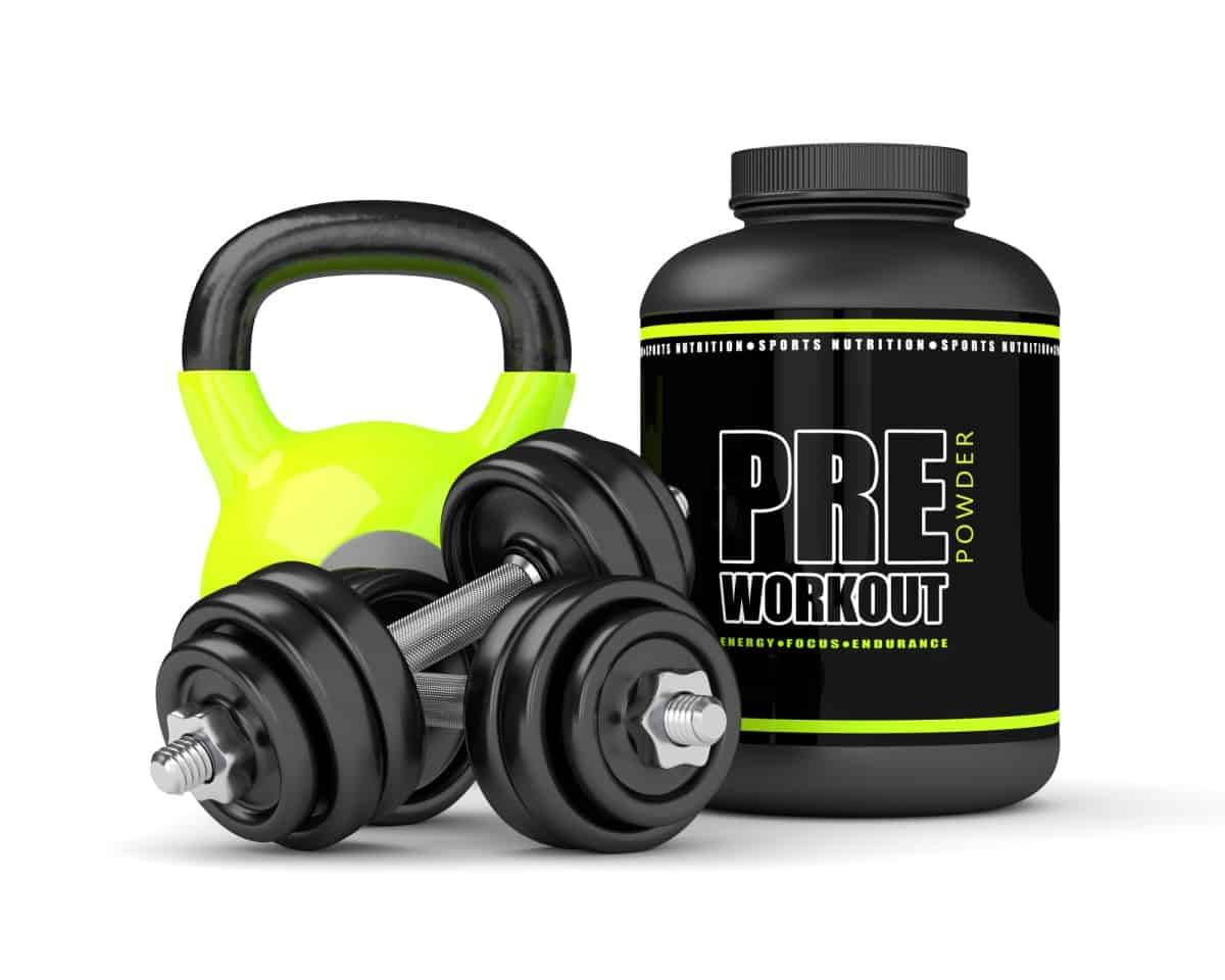 A bottle of pre-workout supplement next to dumbbells and a kettlebell.