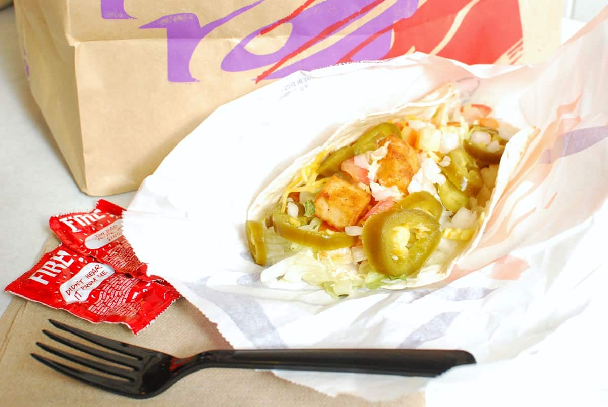 A spicy potato soft taco with added jalapenos, tomatoes, and onion.