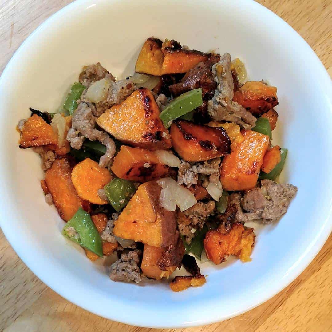 A sweet potato turkey hash in a white bowl.