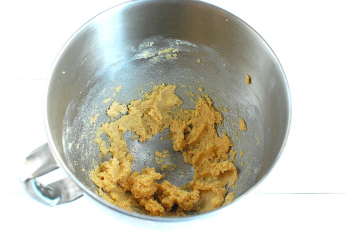 Butter and brown sugar creamed together in a mixing bowl.