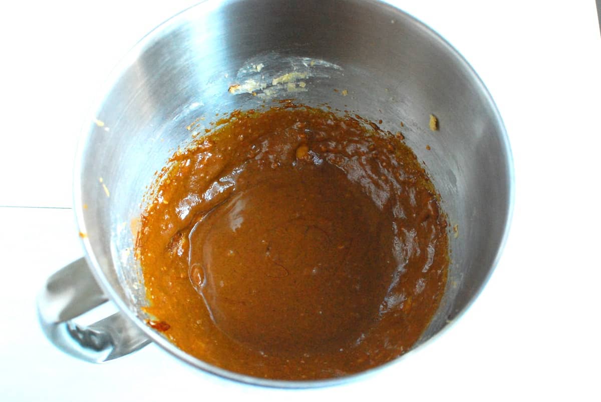 Molasses, cashew butter, egg, vanilla, ginger, cinnamon, and cloves mixed in with the butter and brown sugar in the mixing bowl.