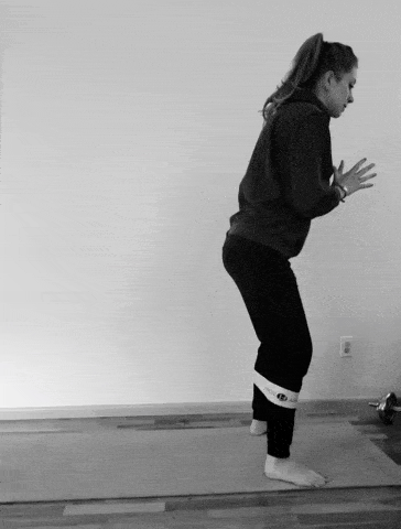 A woman doing a backwards monster walks exercise.