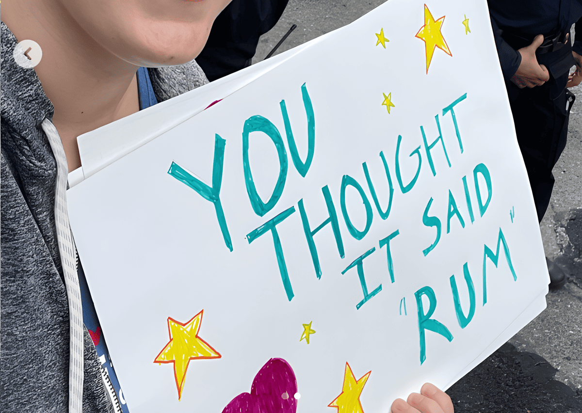 A spectator holding a "you thought it said rum" sign for runners.