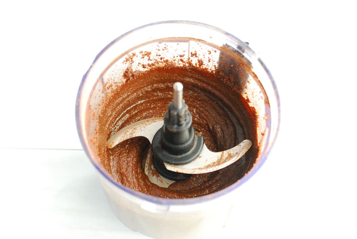 A small food processor bowl with homemade chocolate hazelnut spread.