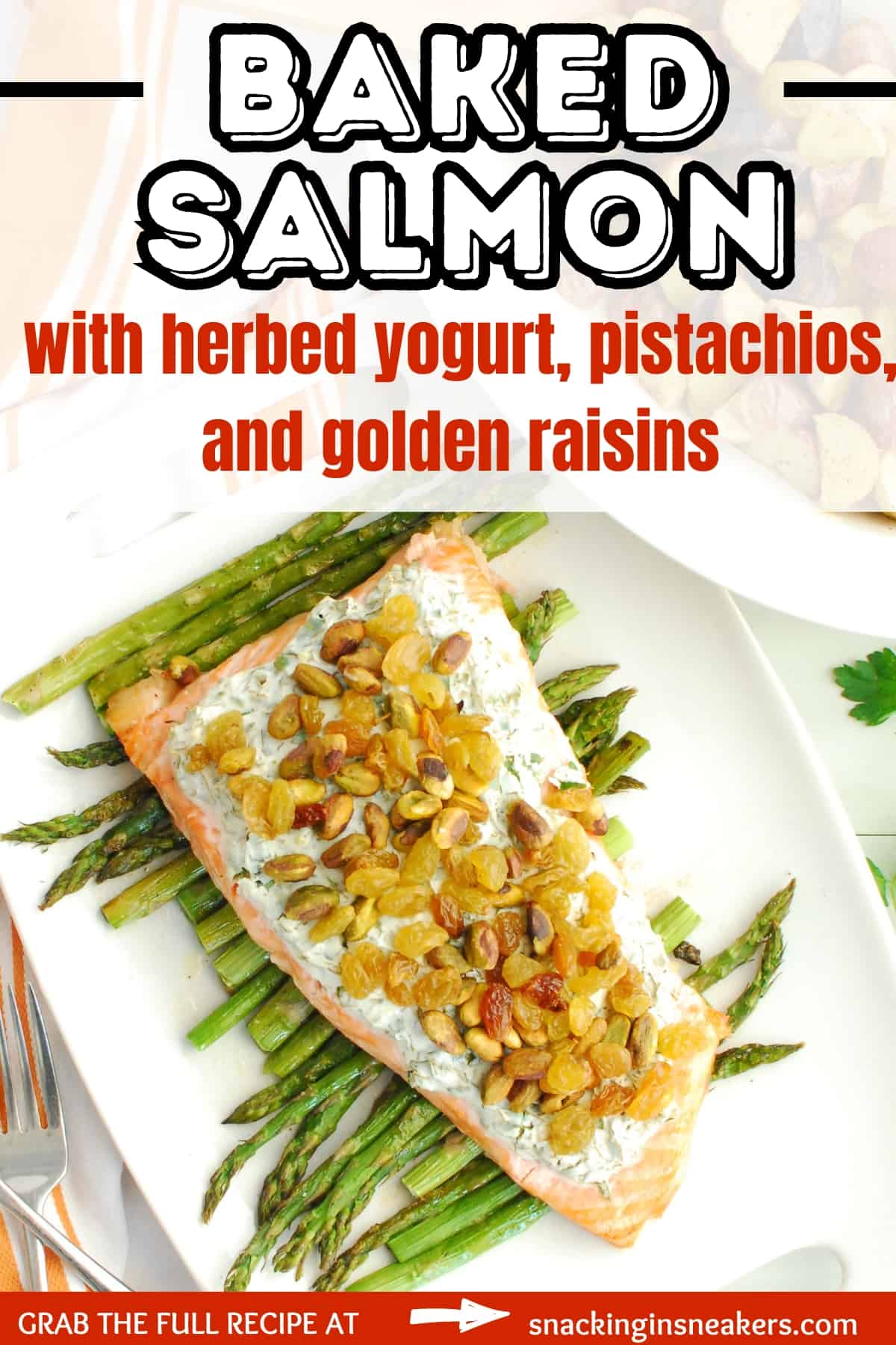 A baked salmon fillet with herbed yogurt sitting on roasted asparagus on a white platter, with a text overlay with the name of the recipe.