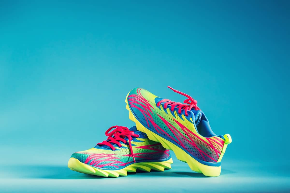 A pair of colorful running sneakers with a blue background.