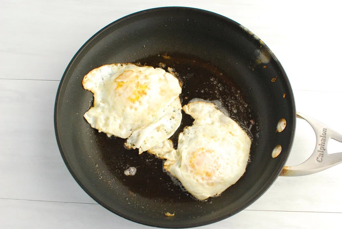 Two fried eggs in a pan.