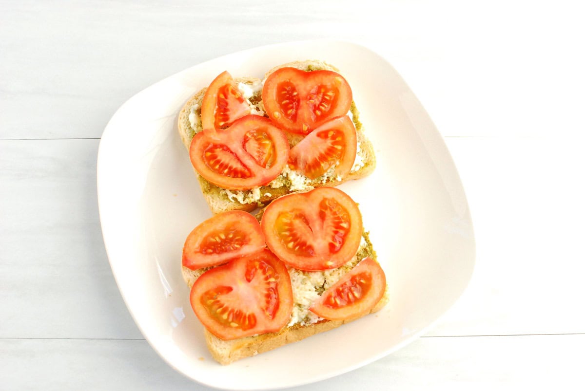 Tomato slices added on top of the toast.