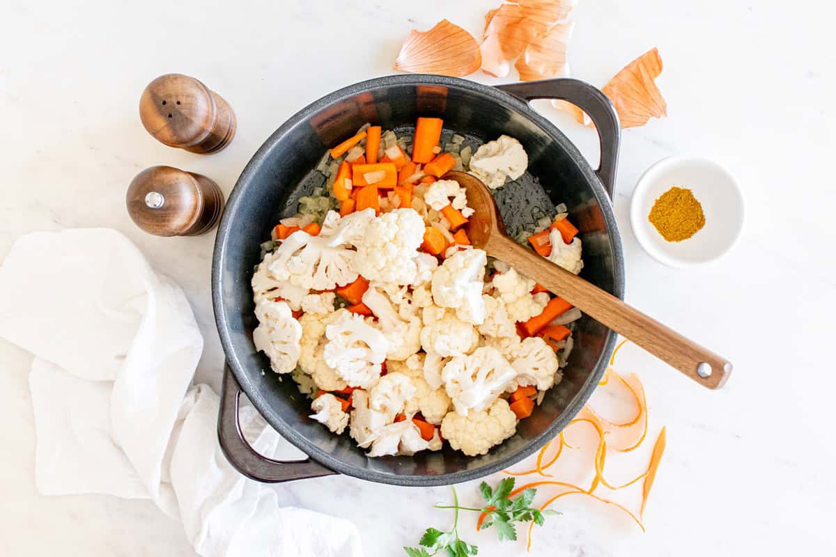 Cauliflower added to the pot with the carrots and onions.