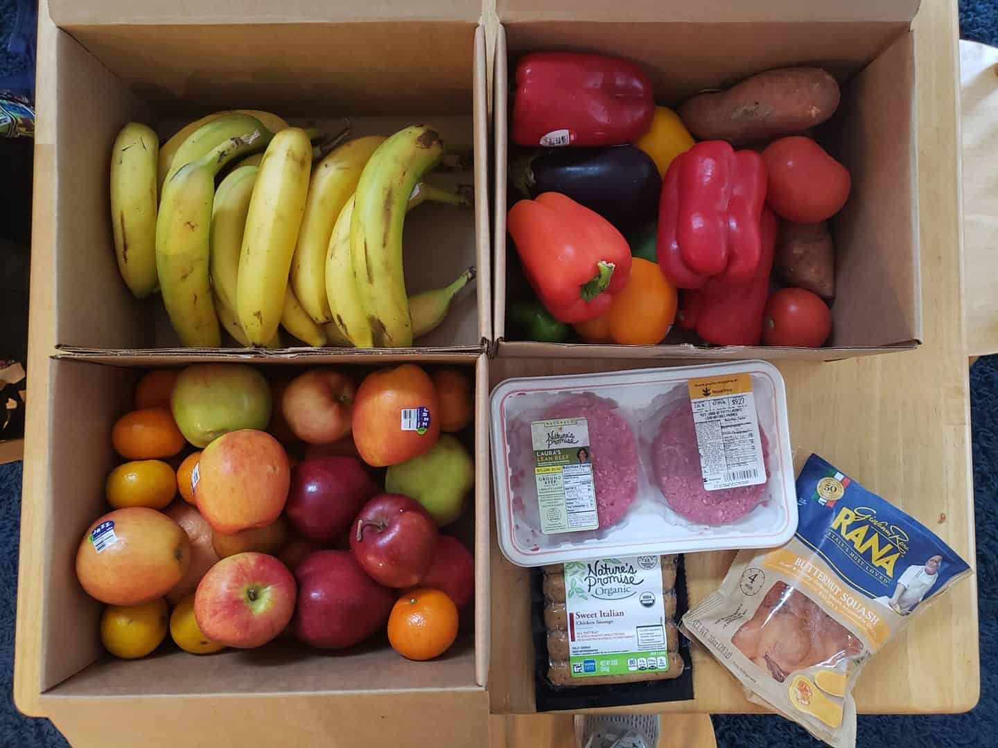 An order of bananas, vegetables, fruit, burgers, sausage, and ravioli.