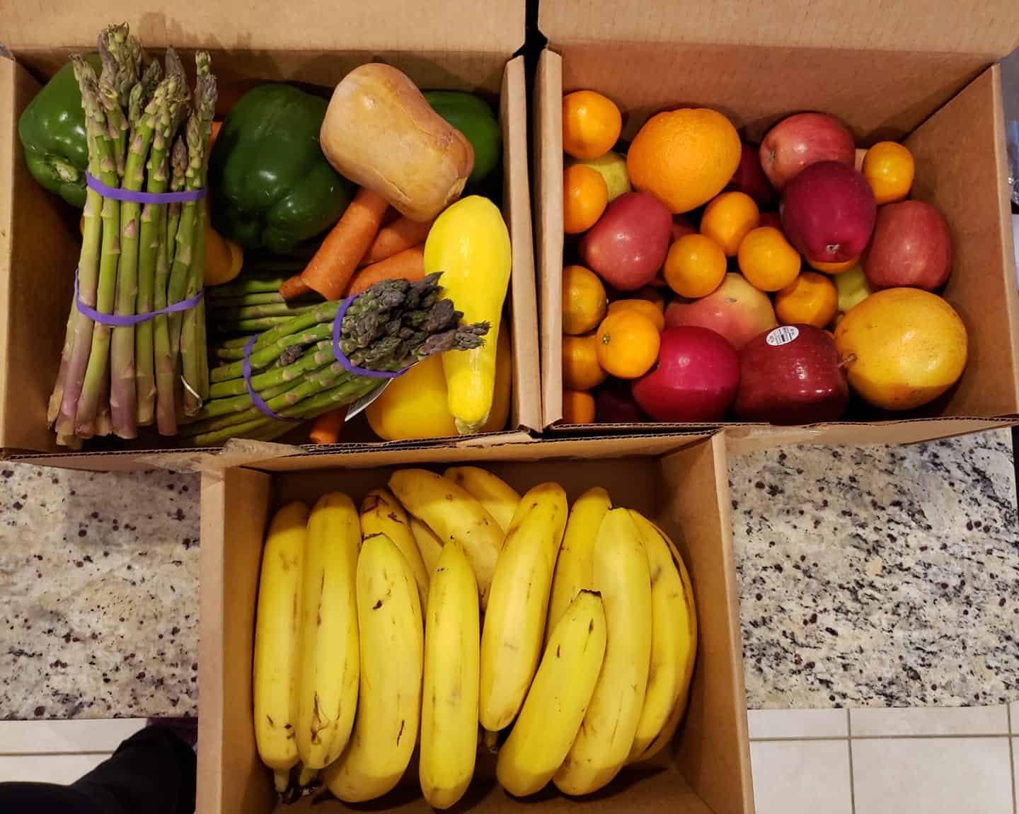 A box of mixed vegetables, mixed fruit, and bananas.