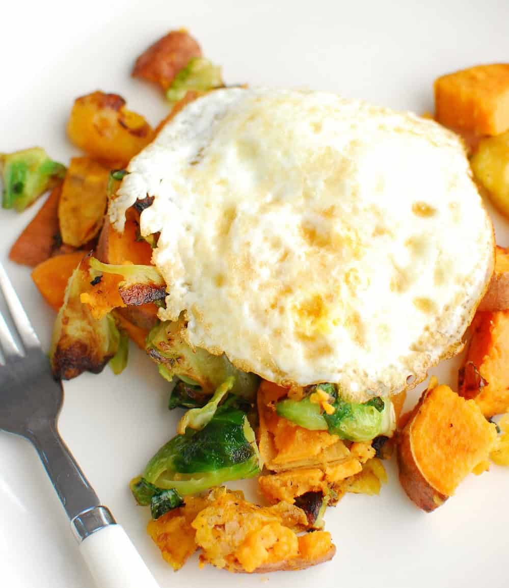 A breakfast hash with sweet potatoes, brussels sprouts, and eggs.