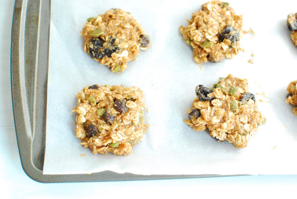 Unbaked cookies on a parchment-lined baking sheet.