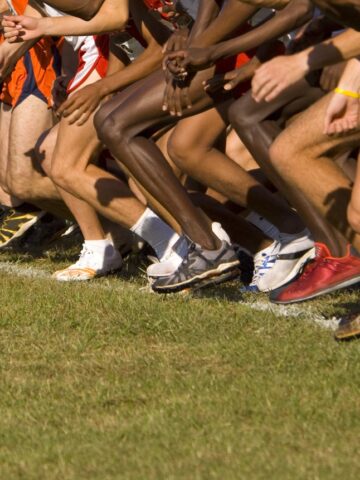 A group of cross country runners starting a race.