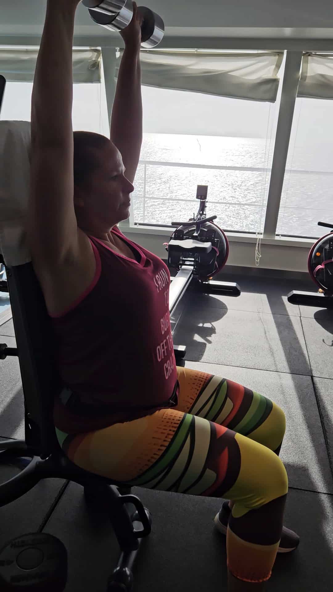 A woman using the gym on a cruise ship.
