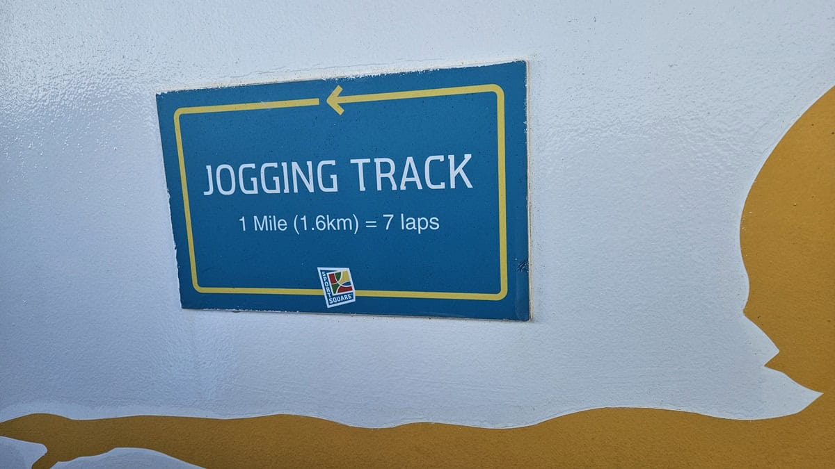 A sign that says 1 mile is equal to 7 laps on the cruise jogging track.