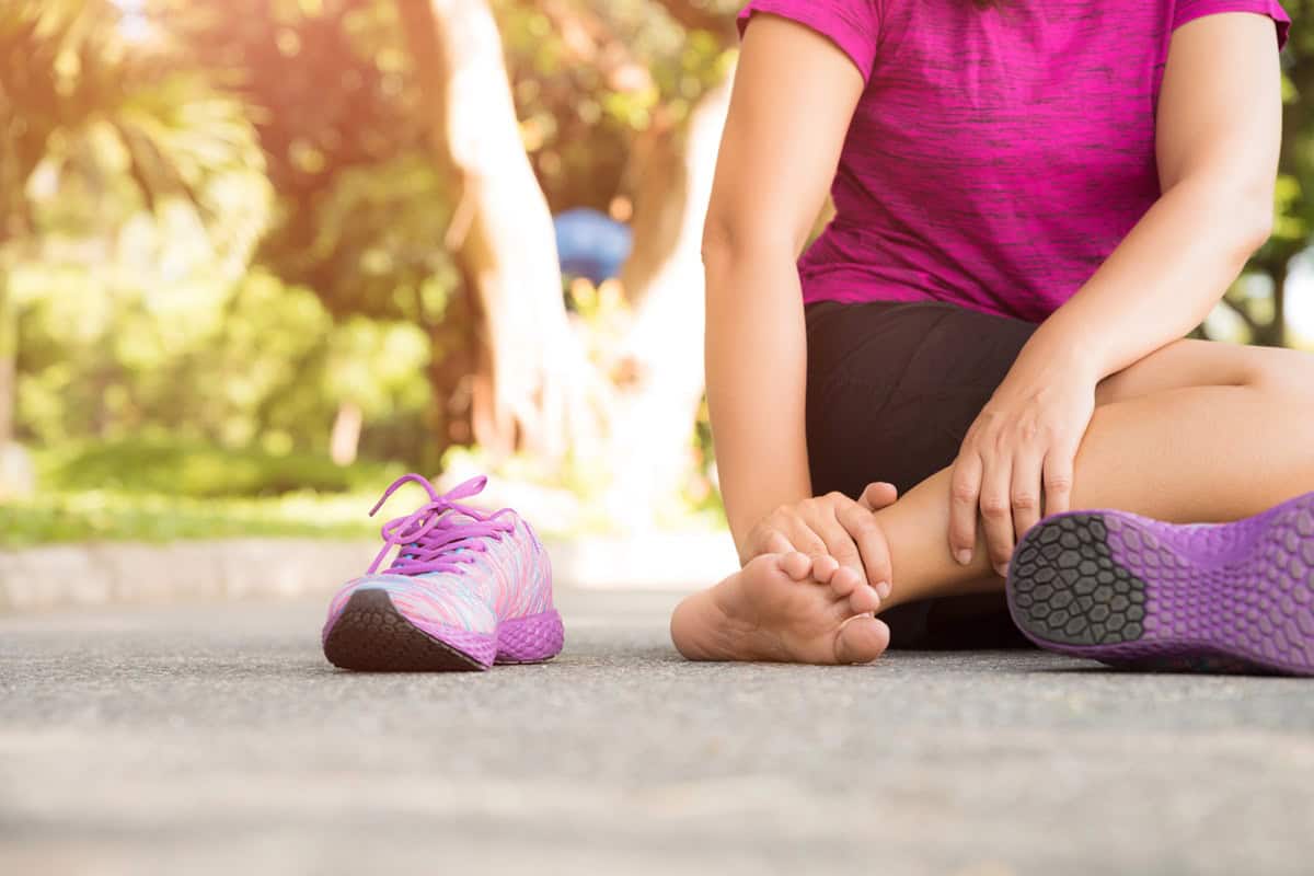 A woman with sore calf muscles after running.