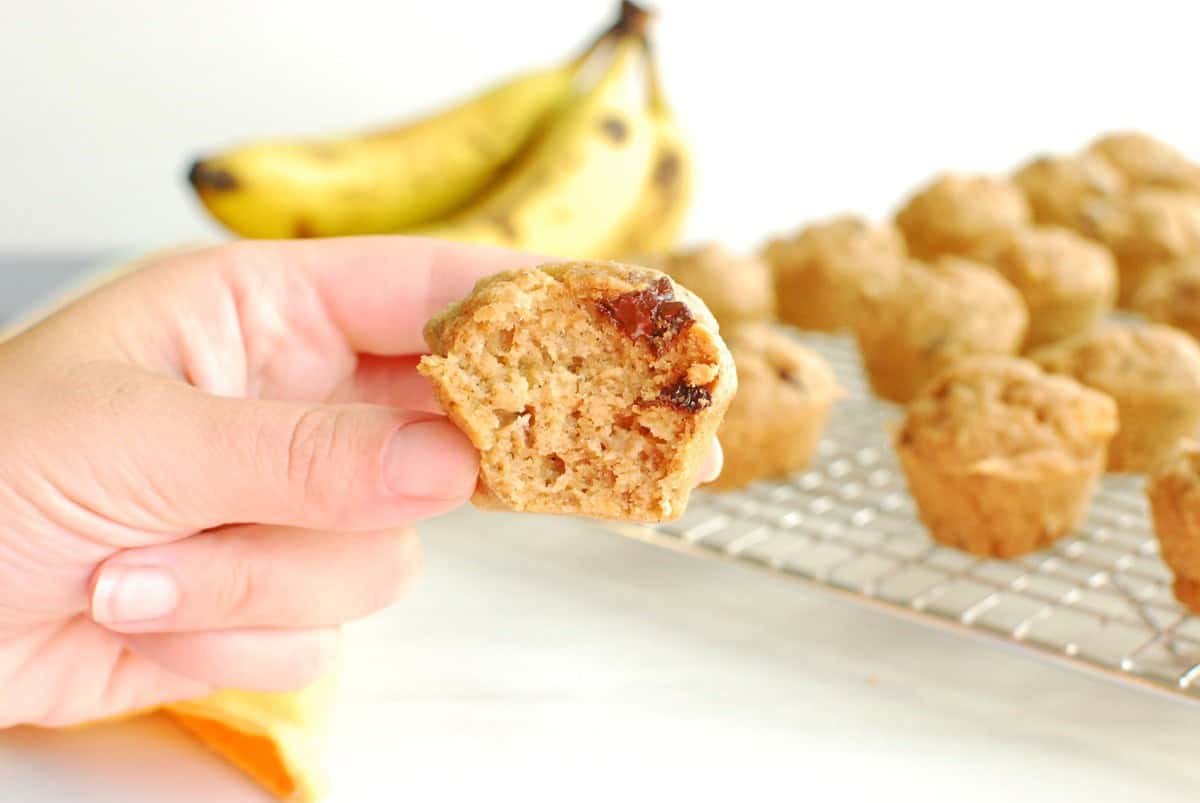 A mini muffin with a bite taken out of it.