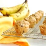 A peanut butter banana mini muffin on a cooling rack.